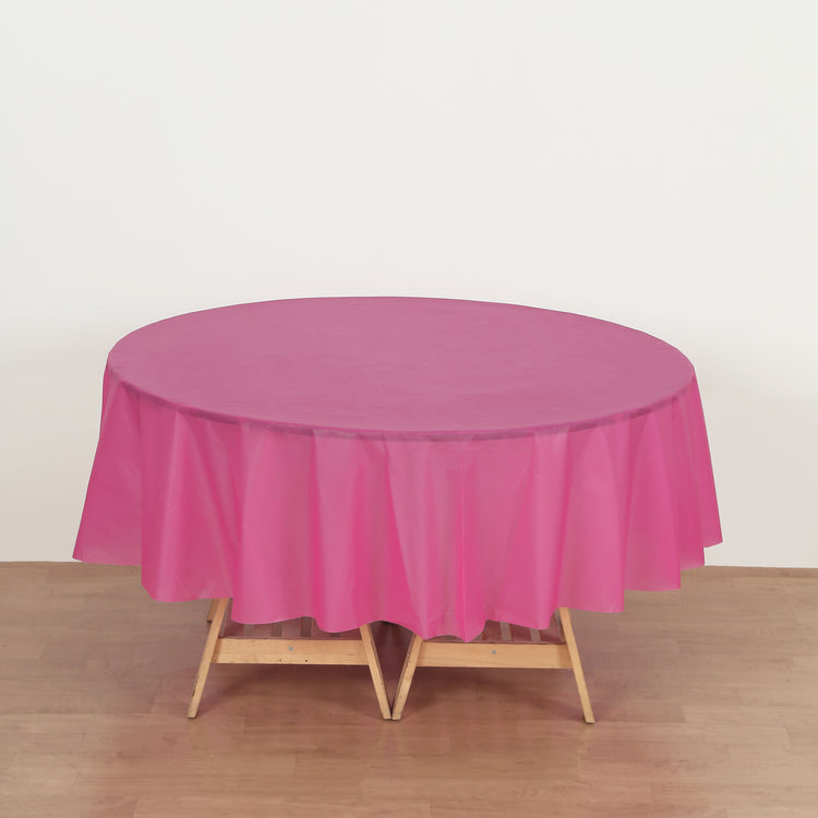 round fuchsia plastic table cover
